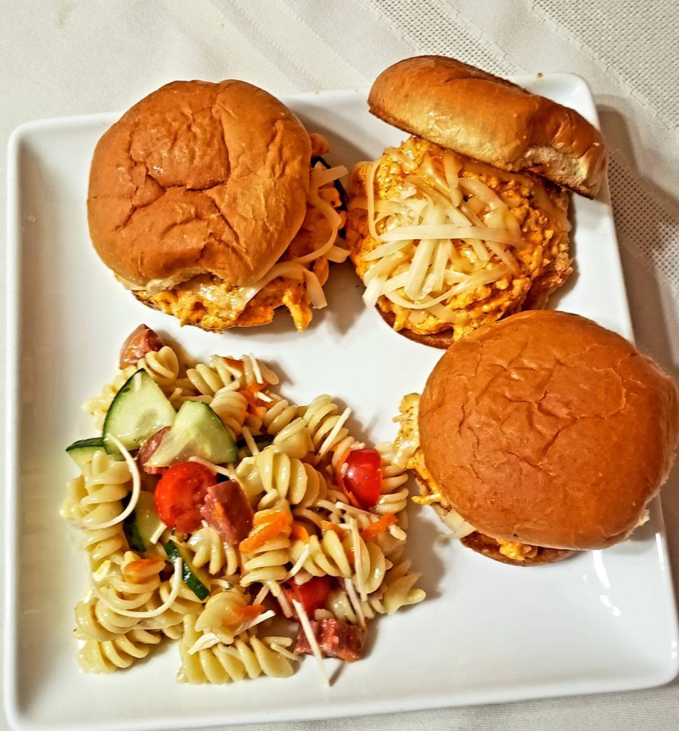 burgers, fries, and pasta with vegetables